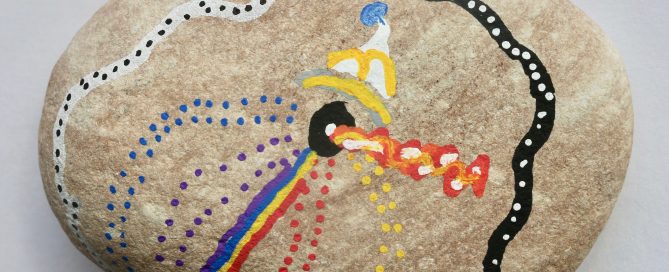 "Unspeakable" a piece done in acrylic markers on a natural stone by Snow City student Kobe. The pieces shows an abstract design of multicolored dots, stripes and forms.